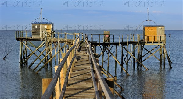 Traditional carrelet fishing huts with lift nets on the beach