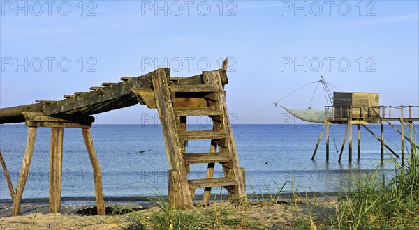 Traditional carrelet fishing hut with lift net on the beach