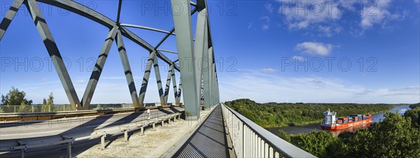 Hochbruecke Gruenental with Kiel Canal and container ship near Beldorf