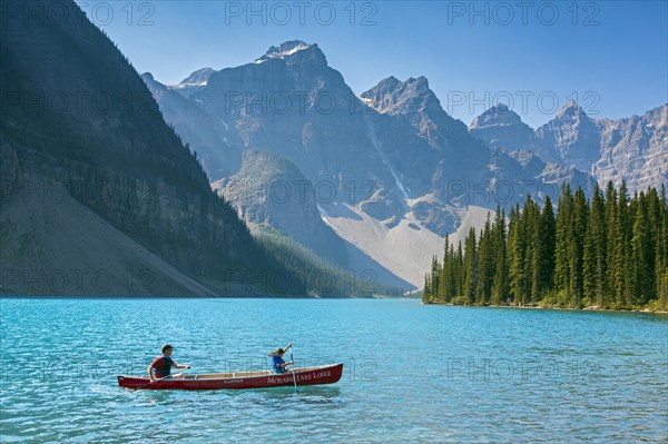 Tourists in canoe on Moraine Lake in the Valley of the Ten Peaks