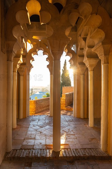 Watching the sunset from the Arab doors of a courtyard of the Alcazaba in the city of Malaga