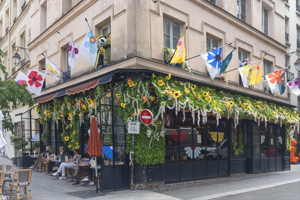 Street cafe decorated with artificial flowers