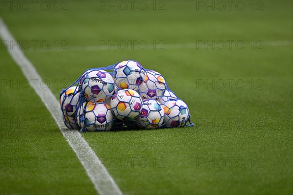 Adidas Derbystar match balls lie in ball net on grass