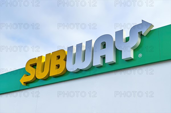 Yellow white lettering logo Subway over restaurant fast food restaurant of fast food chain