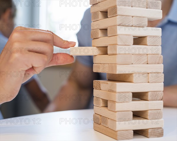 Close up family playing jenga together
