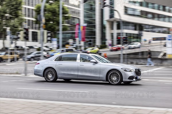 Car at night in front of urban surroundings with modern architecture