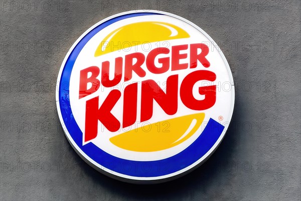 Logo and advertising on wall of building for fast food chain Burger King