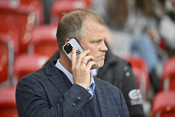 Sports director Fabian Wohlgemuth VfB Stuttgart on mobile phone