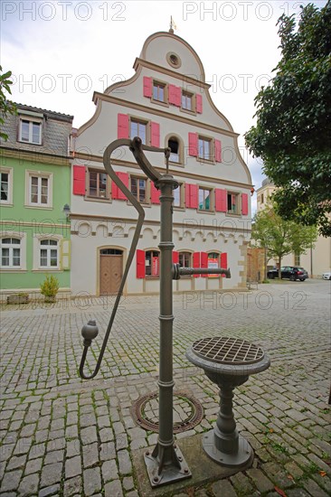 Pump well and half-timbered house with tail gable