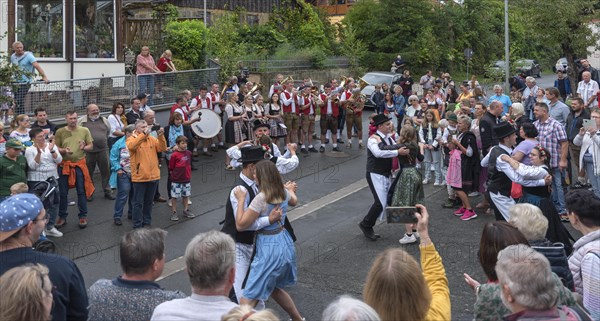 Dance of the Kirchweih couples with brass band on the street on the day of the traditional Tanzlindenfest