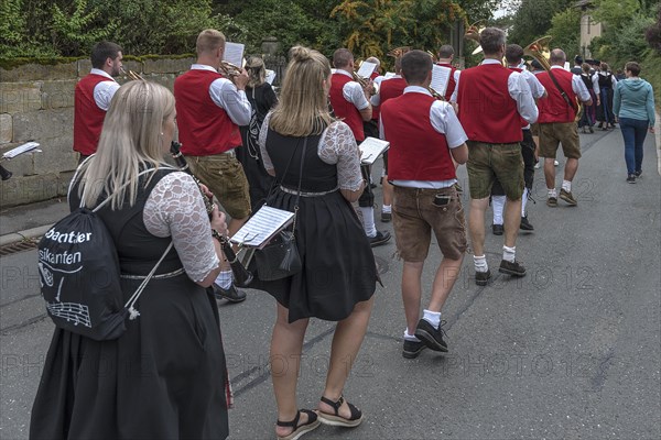 Brass band marches through the village on the day of the traditional Tanzlindenfest