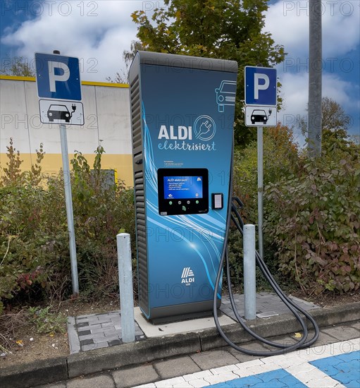 Charging station for e-car in front of supermarket of supermarket chain Aldi Sued next to it traffic sign Parking spaces for two e-cars can be charged