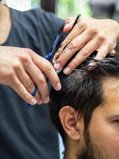 Close up customer getting haircut