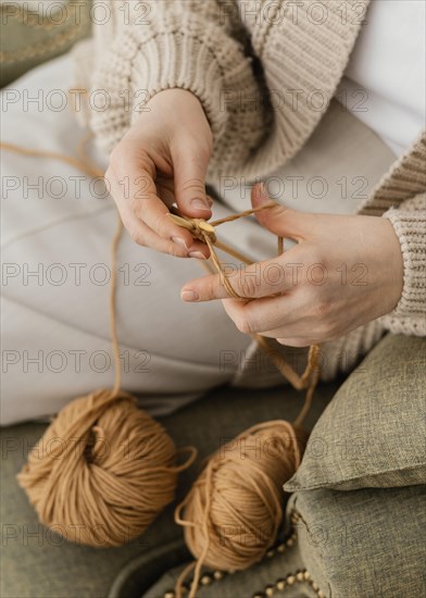 Close up hands knitting with yarn