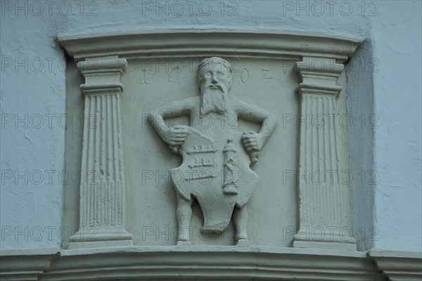 Figure with town coat of arms