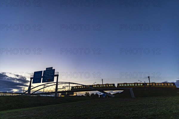 Network arch bridge over the A8 motorway. Light rail bridge of the SSB for the U6 airport line. The span of the arches is 80 metres. Tension elements made of carbon. The U6 line light rail bridge received the German Bridge Construction Award in 2023