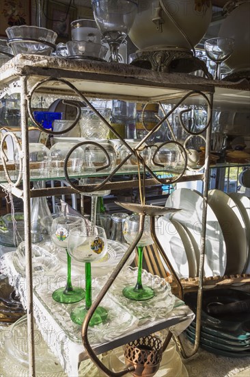 Old wine and liquor glasses for sale inside second hand goods and chattels store