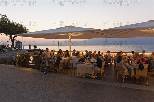 Restaurant terrace with guests on the lake shore