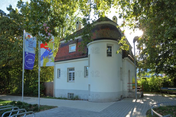 Annexe of the adult education centre Villa Arnold backlit with flags