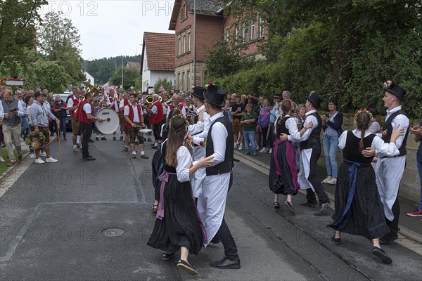 Dance of the Kirchweih couples with brass band on the street on the day of the traditional Tanzlindenfest