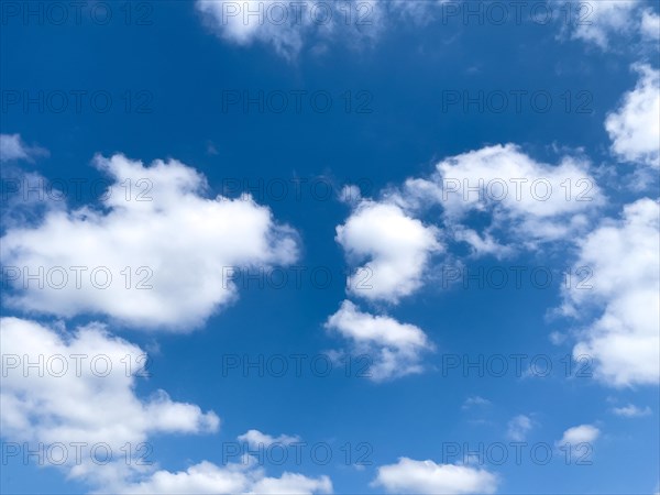 White clouds altocumulus on blue in front of blue sky