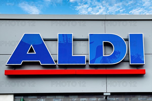 Logo lettering Aldi in blue with red underline on wall of supermarket of supermarket chain retail chain Aldi Nord