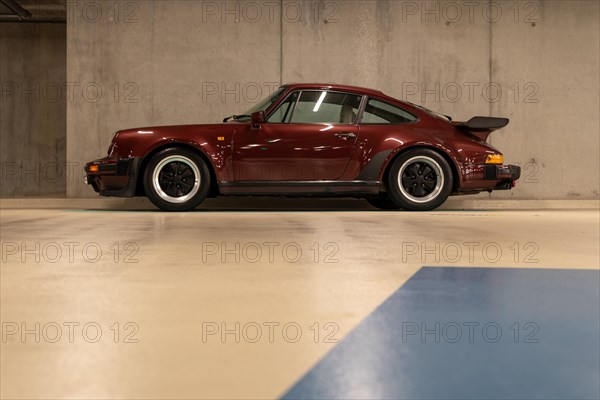 Wine-red Porsche in an underground car park