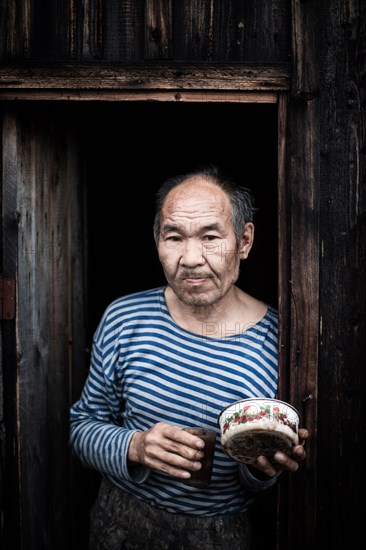 Hermit in front of his hut