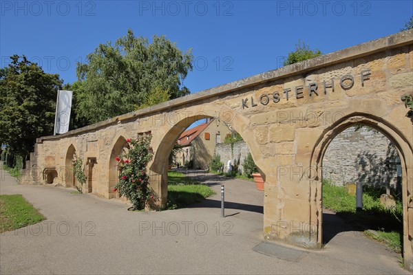 Historic stone wall with archways and monastery courtyard