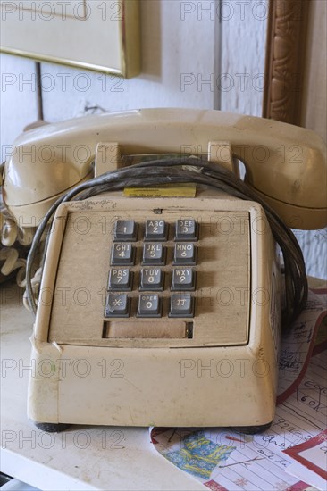 Vintage touch tone analog telephone for sale inside second hand goods and chattels store