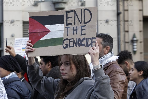 Demo participant holds sign Genocide