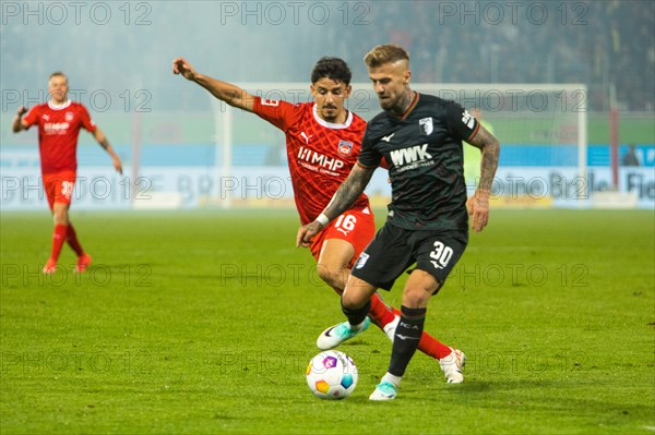 Niklas DORSCH FC Augsburg r. in duel with Kevin SESSA 1.FC Heidenheim