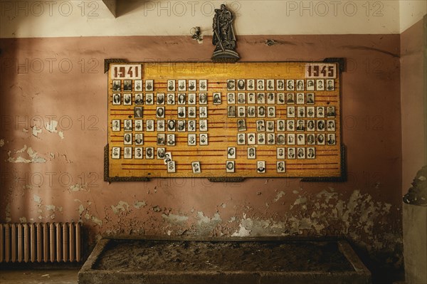 Panel with pictures of fallen soldiers of the Second World War in the cultural house of Okumi