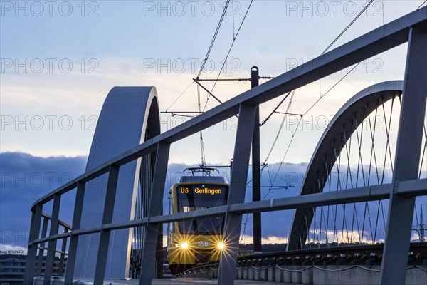 Network arch bridge over the A8 motorway. Light rail bridge of the SSB for the U6 airport line. The span of the arches is 80 metres. Tension elements made of carbon. The U6 line light rail bridge received the German Bridge Construction Award in 2023