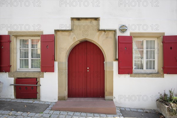 Entrance of the historic poorhouse with the year 1486