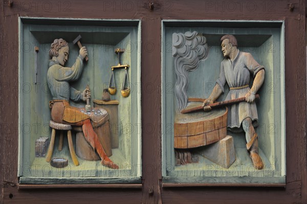 Relief with profession locksmith and blacksmith with figures