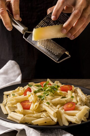 Close up cook grating cheese