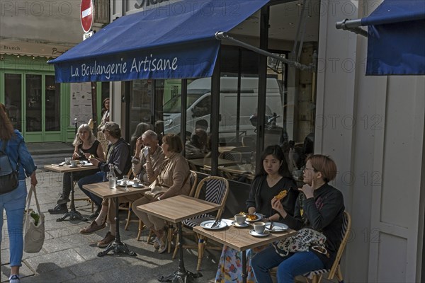 Tourists in a small street cafe