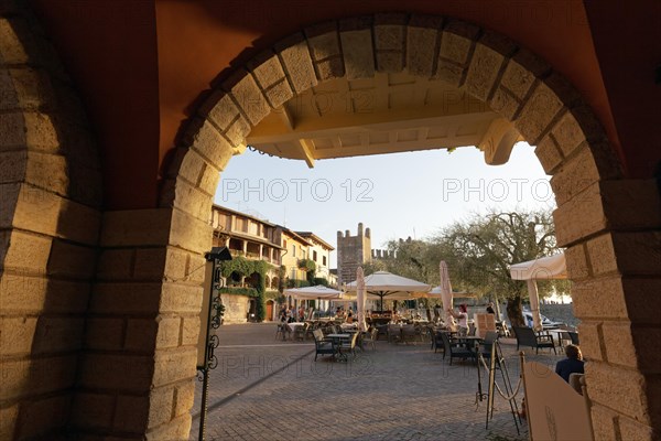 View through arcades of Piazza Calderiini and Scaliger Castle