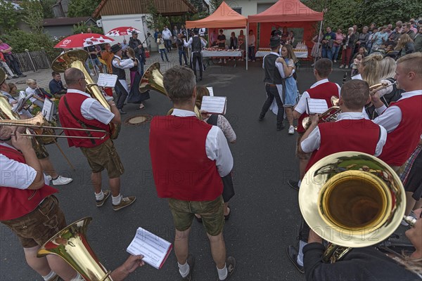 Dance of the Kirchweih couples with brass band on the street on the day of the traditional Tanzlindenfest