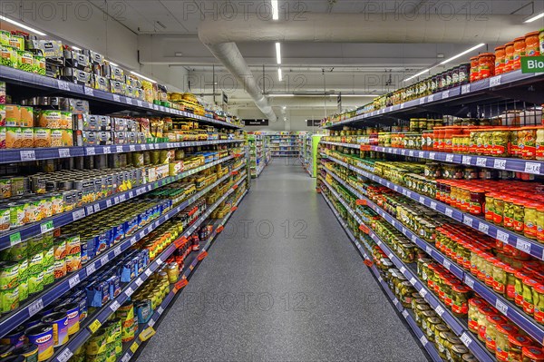 Shelves with food in cans and jars