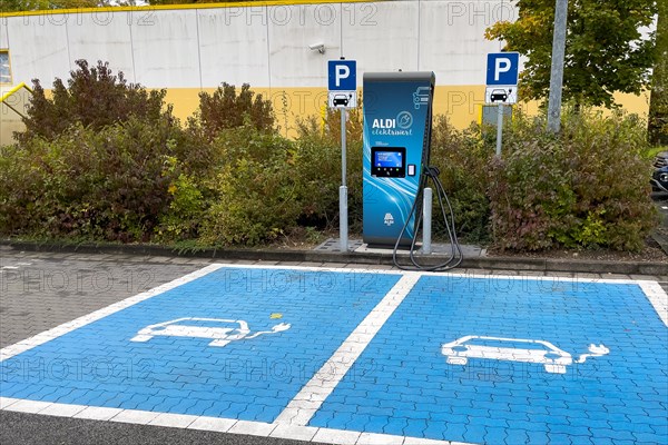 Charging station for e-car in front of supermarket of supermarket chain Aldi Sued next to it traffic sign parking spaces two e-cars can be charged