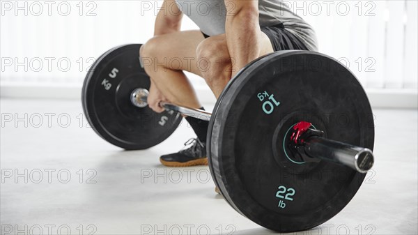 Close up hands lifting weight indoors