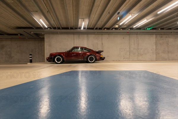 Wine-red Porsche in an underground car park