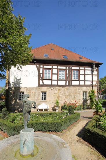 Half-timbered house Fuggerei built 14th century and park with sculpture