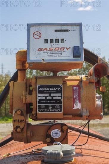 Old Gasboy diesel fuel pump connected to top of dispenser tank