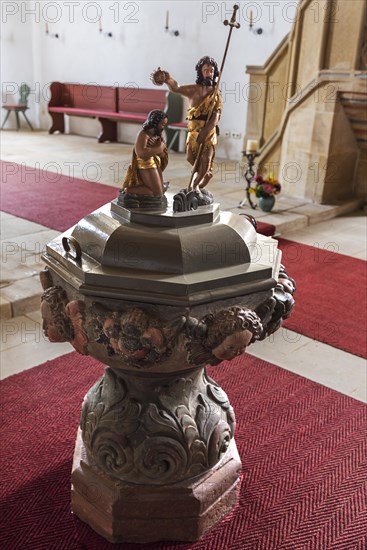 Baptismal font in the late Gothic church of St. John the Baptist