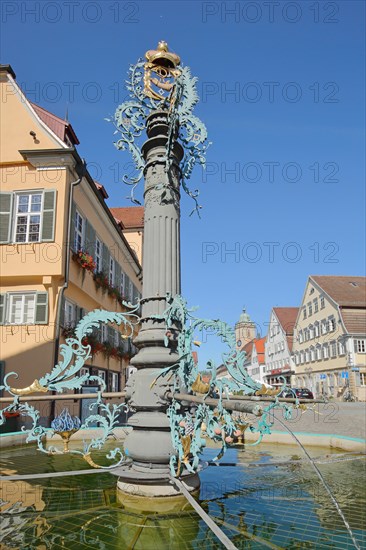Market fountain with column and golden ornaments