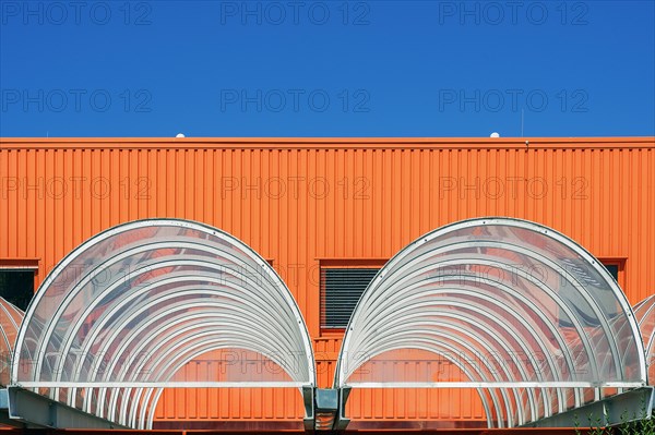 Orange facade and acrylic glass roofing