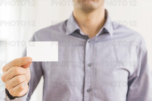 Close up businessman showing blank white visiting card